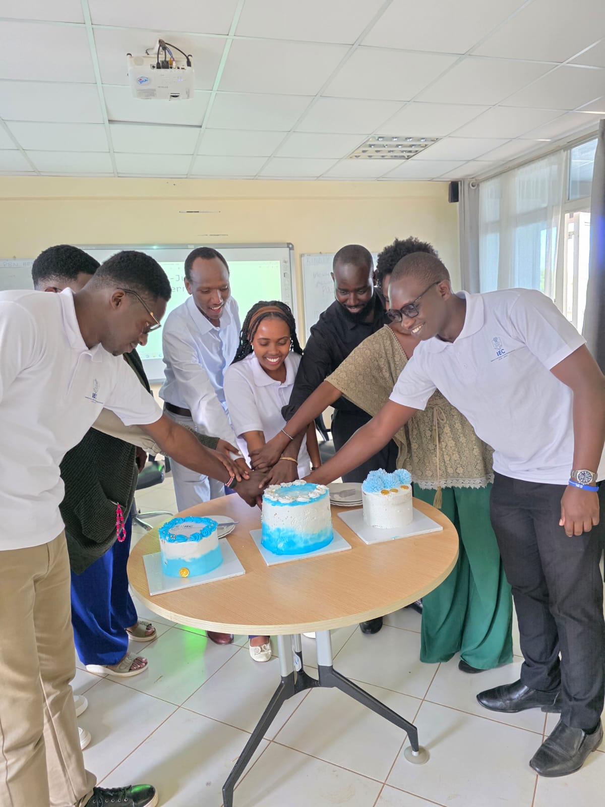 Members cutting a celebration cake