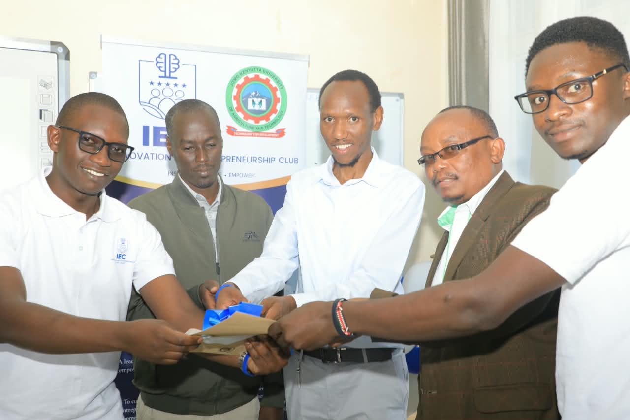 IEC award handover in front of the club banner